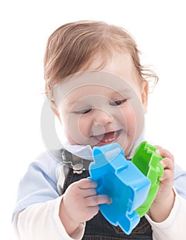 Portrait of happy baby boy playing with toys
