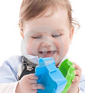 Portrait of happy baby boy playing with toys