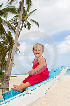 Portrait of happy baby child on board of sea boat