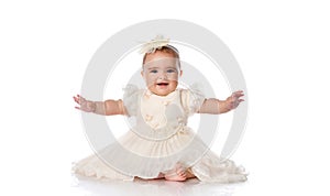 Portrait of a happy baby girl in festive clothes on a white background.