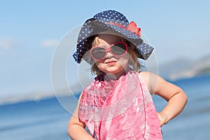 Portrait of happy baby girl in hat and sunglasses