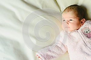 Portrait of happy baby girl with pink pajamas