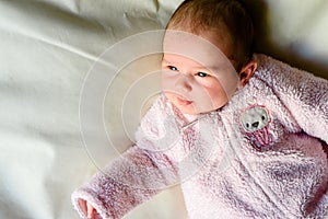 Portrait of happy baby girl with pink pajamas