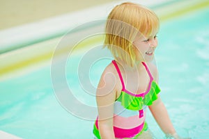 Portrait of happy baby girl in swimming pool