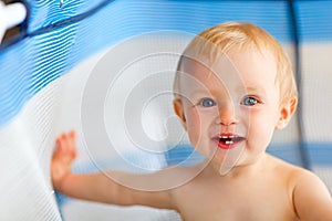 Portrait of happy baby in playpen