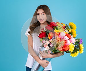 portrait of happy beautiful asian woman holding bouquet of flower