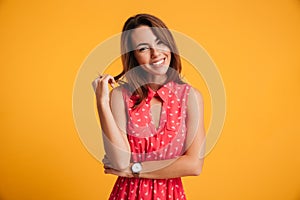Portrait of a happy beautiful brunette woman in red dress, touch