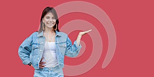 Portrait of happy beautiful brunette young woman with makeup in denim casual style standing, hand on copyspace and looking at