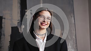 Portrait of happy beautiful caucasian young woman creative employee looking at camera and smiling in modern office