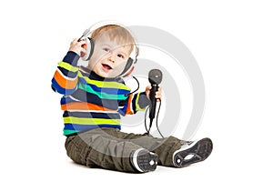 Portrait of happy beautiful little boy isolated on white background. Baby and a microphone.