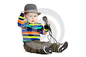 Portrait of happy beautiful little boy isolated on white background. Baby and a microphone.