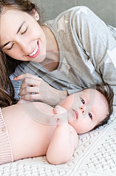 Portrait of happy beautiful mother and cute newborn baby girl