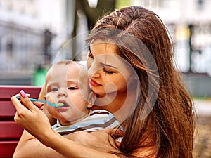 Portrait of happy beautiful mother feed her baby