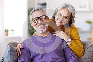 Portrait of happy beautiful senior caucasian family couple in love smiling at camera at home