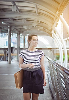 Portrait of happy beautiful woman smling and holding shopping bags in city,Lifestyle concept