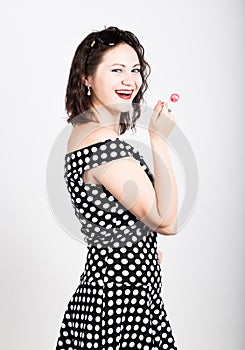 Portrait of happy beautiful young woman licking sweet candy and expressing different emotions. pretty woman with heart