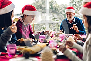 Portrait of happy big family celebrating santa hats having fun and lunch together enjoying spending time together in christmas