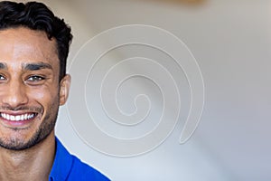 Portrait of happy biracial man looking at camera and smiling with copy space