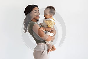 Portrait Of Happy Black Family, Mother With Adorable Infant Son On Hands