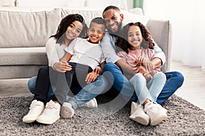 Portrait of a happy black family posing at camera