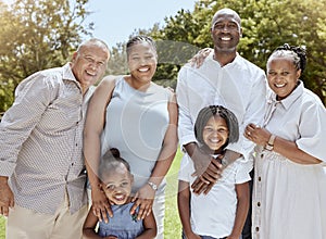 Portrait of happy black family with smile in park, garden or outdoor picnic venue. Men, women and kids together on grass