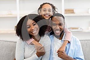 Portrait of happy black family smiling at home
