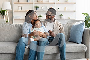 Portrait of happy black family smiling looking at each other