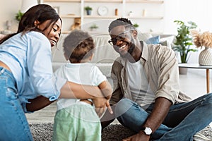 Portrait of happy black family smiling playing at home