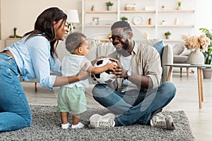 Portrait of happy black family smiling playing at home