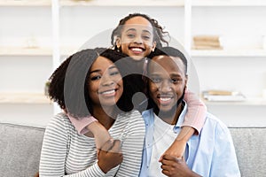 Portrait of happy black family smiling posing for photo