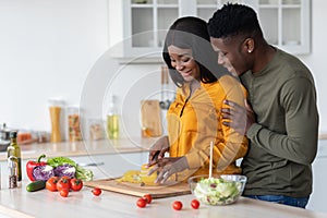 Portrait Of Happy Black Lovers Preparing Healthy Food Together In Kitchen