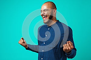 Portrait of a happy black man celebrating his success expressing joy