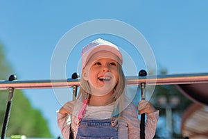 Portrait of happy blonde 4 years girl playing on playground