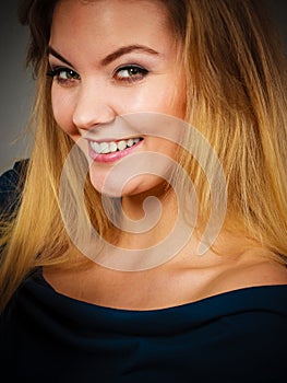 Portrait of happy blonde woman smiling with joy