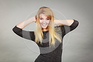 Portrait of happy blonde woman smiling with joy