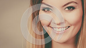 Portrait of happy blonde woman smiling with joy