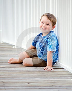 Portrait of happy boy on beach boardwalk