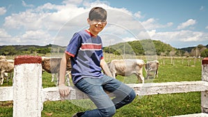 Portrait Of Happy Boy In Farm With Cows In Ranch