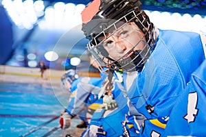 Portrait of happy boy in ice hockey uniform