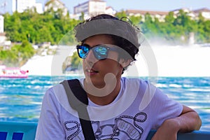 Portrait of happy boy in rhine falls in Switzerland