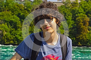 Portrait of happy boy in rhine falls in Switzerland