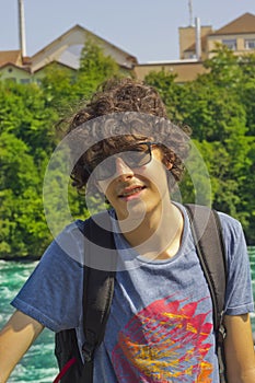 Portrait of happy boy in rhine falls in Switzerland