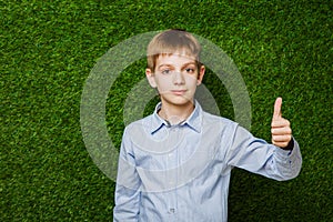 Portrait of happy boy showing thumbs up gesture