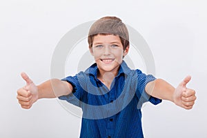 Portrait of happy boy showing thumbs up gesture