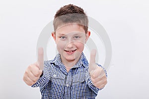 Portrait of happy boy showing thumbs up gesture