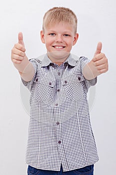 Portrait of happy boy showing thumbs up gesture