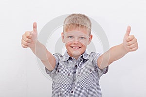 Portrait of happy boy showing thumbs up gesture