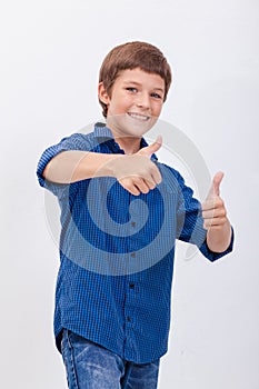 Portrait of happy boy showing thumbs up gesture