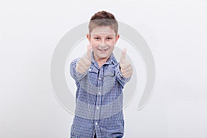 Portrait of happy boy showing thumbs up gesture