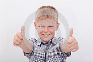 Portrait of happy boy showing thumbs up gesture